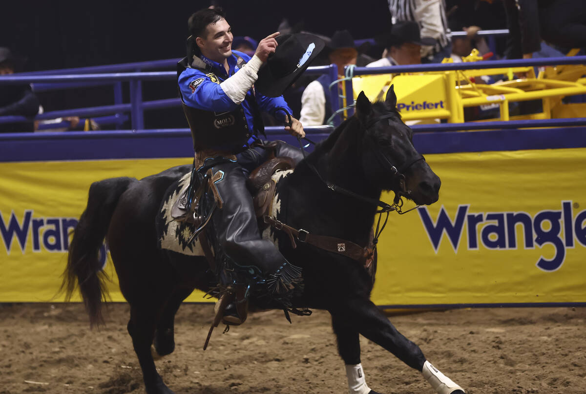 Jess Pope celebrates after placing first in bareback riding during the eighth go-round of the N ...