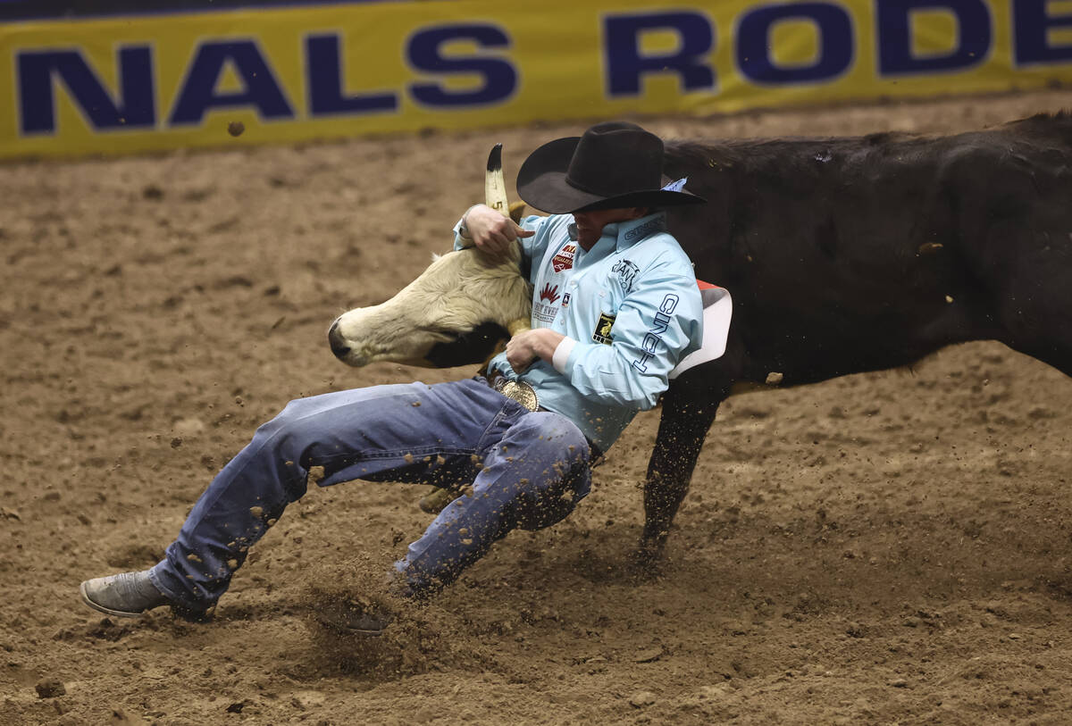 Tucker Allen competes in steer wrestling during the eighth go-round of the National Finals Rode ...