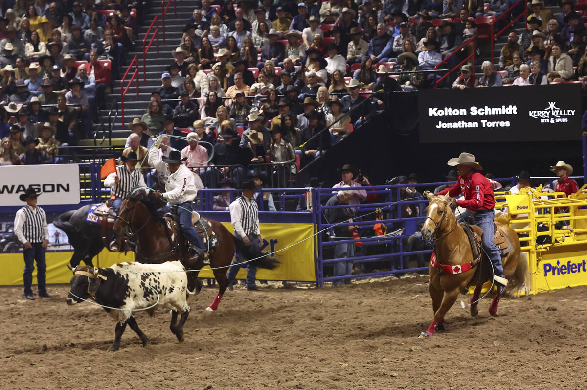 Kolton Schmidt, right, and Jonathan Torres compete in team roping during the eighth go-round of ...