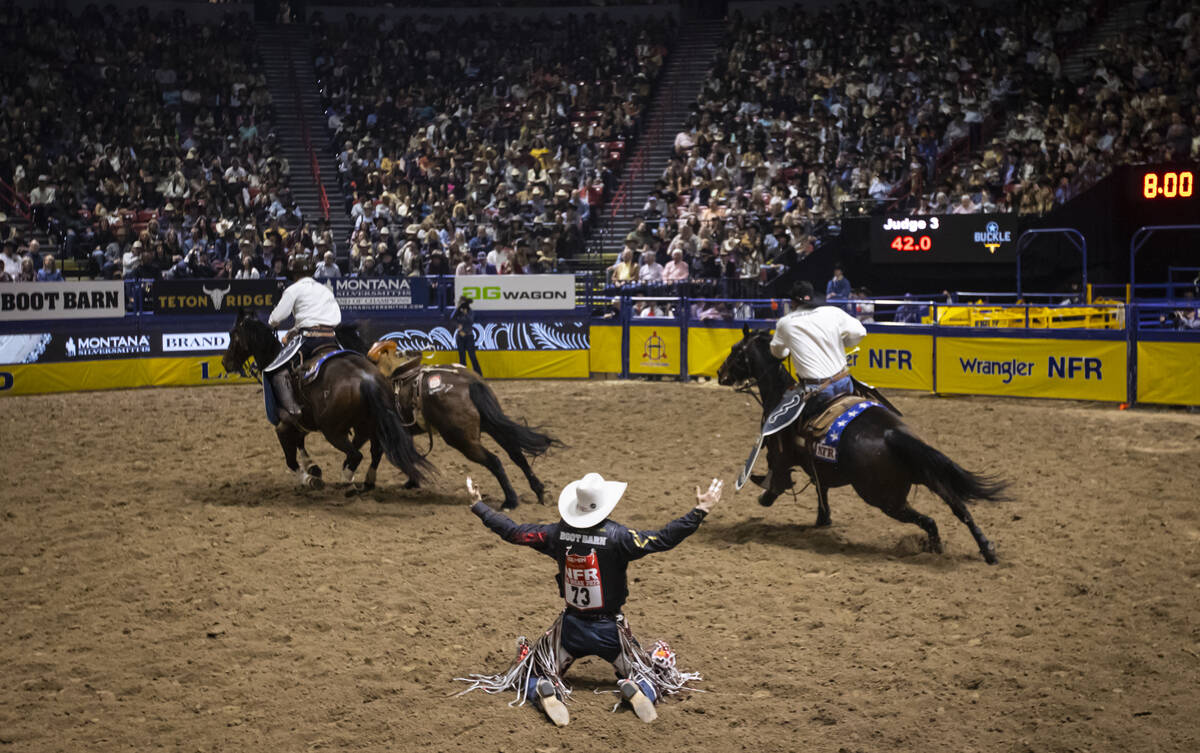 Lefty Holman reacts after competing in saddle bronc riding during the eighth go-round of the Na ...