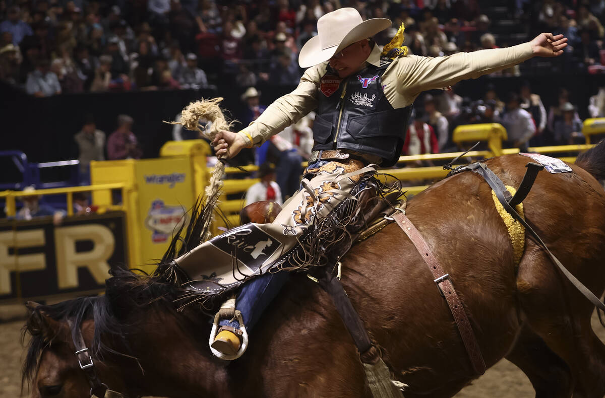 Zac Dallas rides Moose while competing in saddle bronc riding during the eighth go-round of the ...