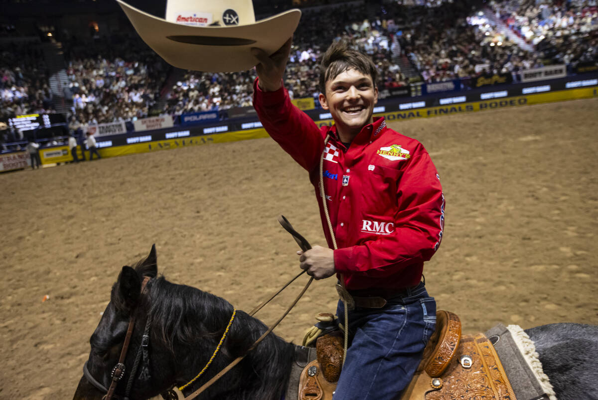 Kincade Henry celebrates after placing first in tie-down roping during the eighth go-round of t ...