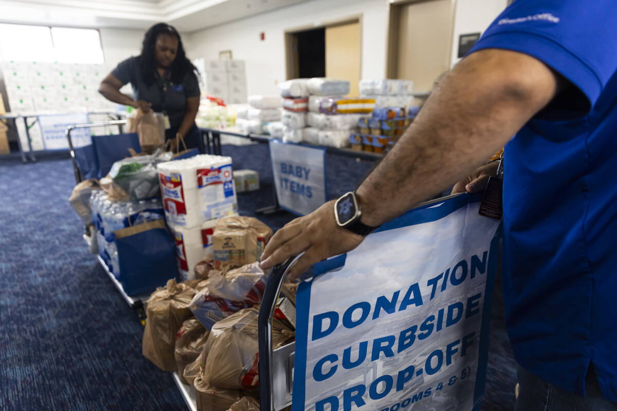 Airport workers bring carts of items to a food pantry for federal employees affected by the gov ...