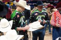 Wrangler NFR bullfighter Dusty Tuckness autographs a cowboy hat for one of the dozens of specia ...