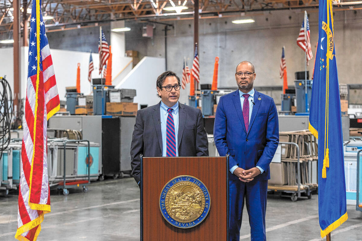 Nevada Secretary of State Francisco Aguilar speaks beside Attorney General Aaron Ford discussin ...