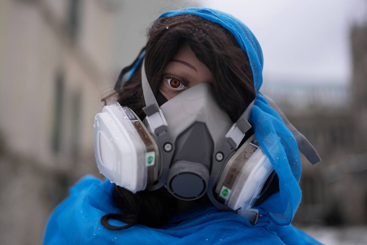 A mannequin representing the Mother Mary wears a mask in the Nativity scene outside of Lake Str ...