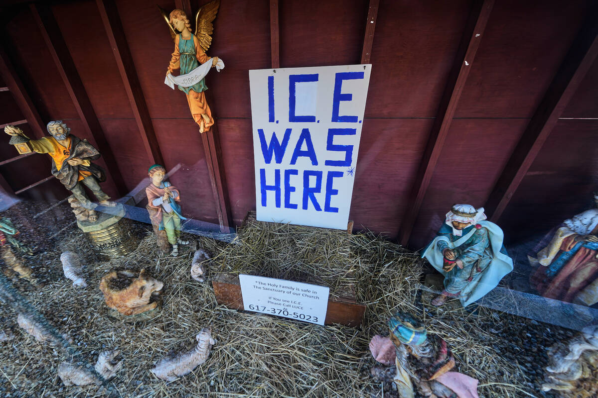 An "ICE WAS HERE" sign is posted in the empty spot for the baby Jesus at a Nativity s ...