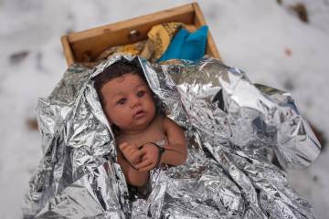A doll representing the baby Jesus is zip-tied in the Nativity scene outside of Lake Street Chu ...