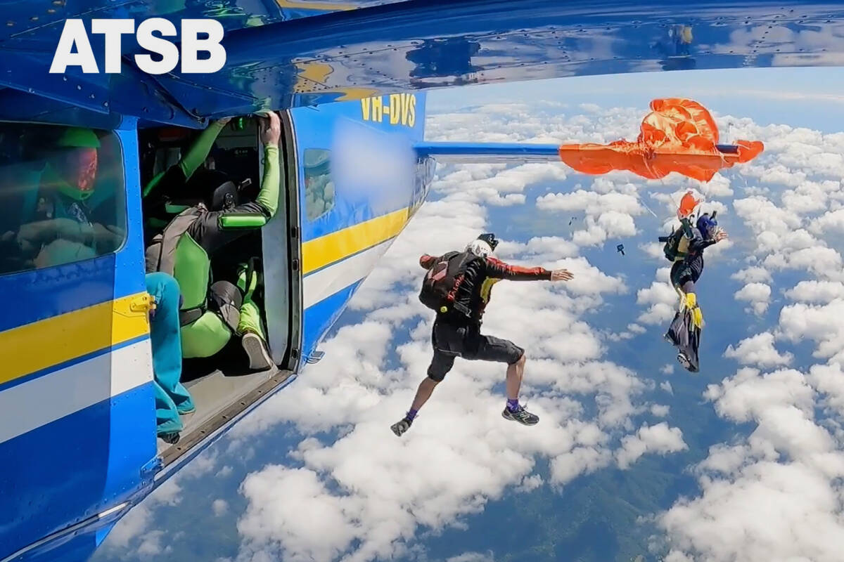 In this imaged taken from a video, a skydiver is caught on the wing of a plane as he exited the ...