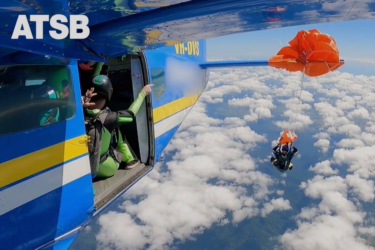 In this image taken from a video a skydiver is caught on the wing of a plane as he exited the a ...
