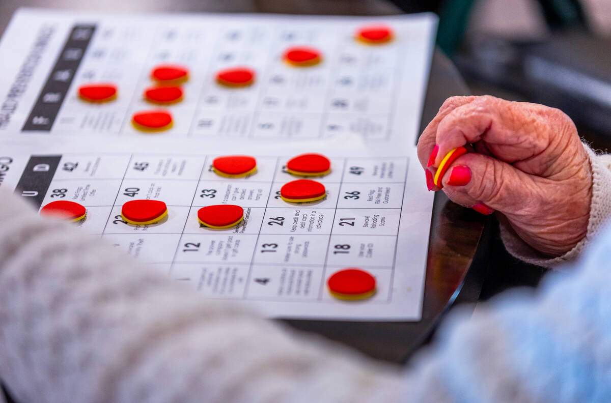A participant looks to mark the next letter and number called as GBank teams with the Independe ...