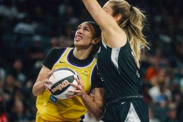 Los Angeles Sparks forward Dearica Hamby (5) is guarded by Aces center Elizabeth Kitley (33) du ...