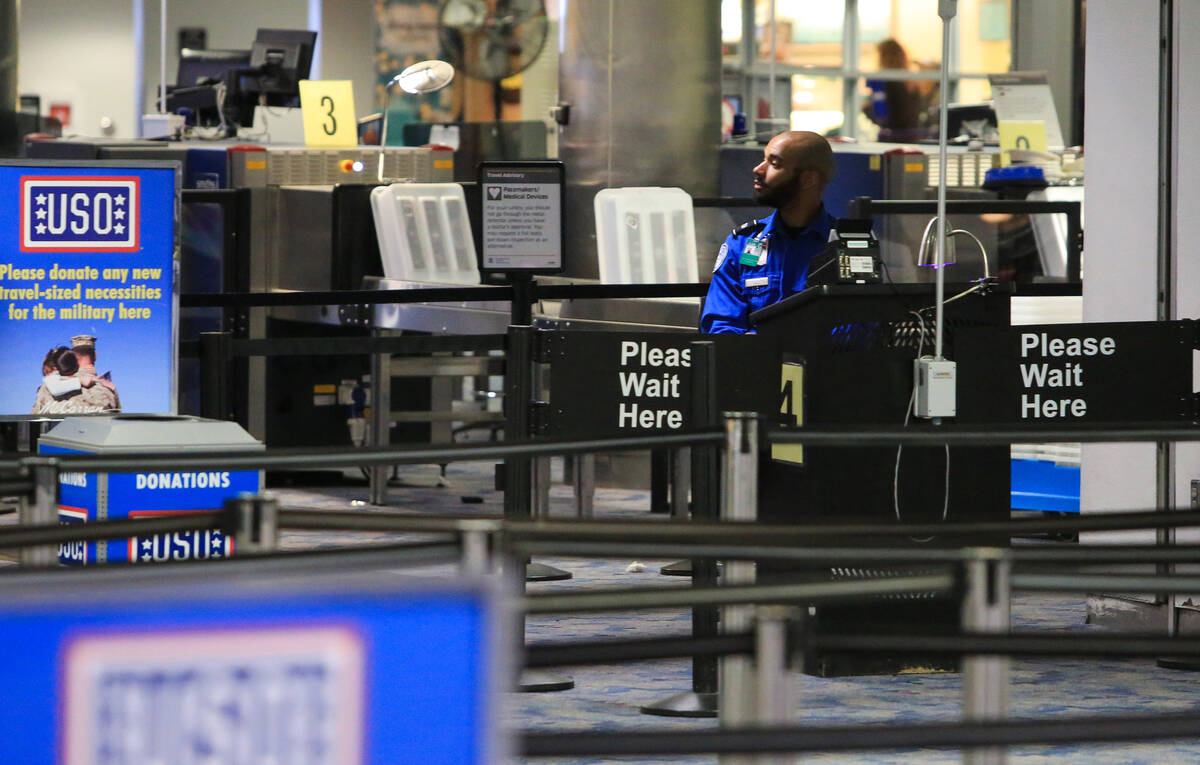 A TSA agent waits for passengers at McCarran International Airport in Las Vegas on Thursday, Ma ...