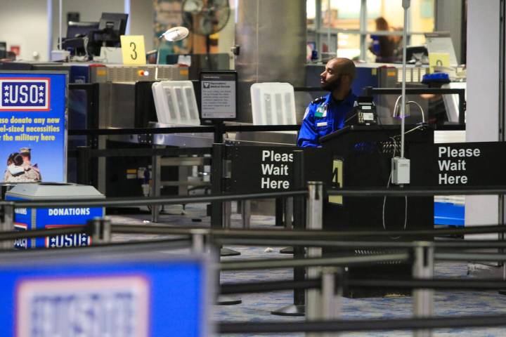 A TSA agent waits for passengers at McCarran International Airport in Las Vegas on Thursday, Ma ...
