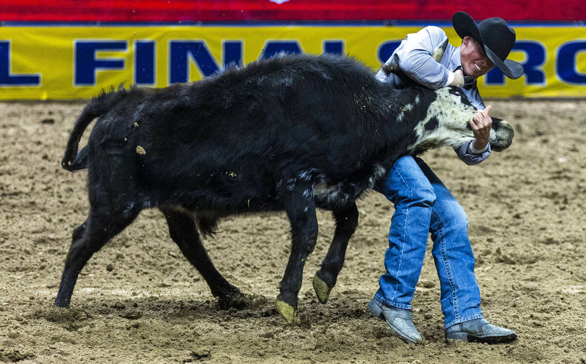 Tucker Allen wraps up his steer for a take down and winning time in Steer Wrestling during the ...