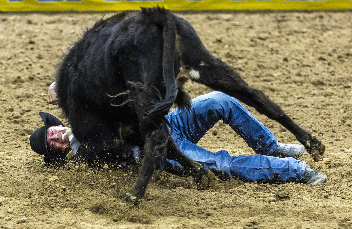 Tucker Allen wraps up his steer for a take down and winning time in Steer Wrestling during the ...