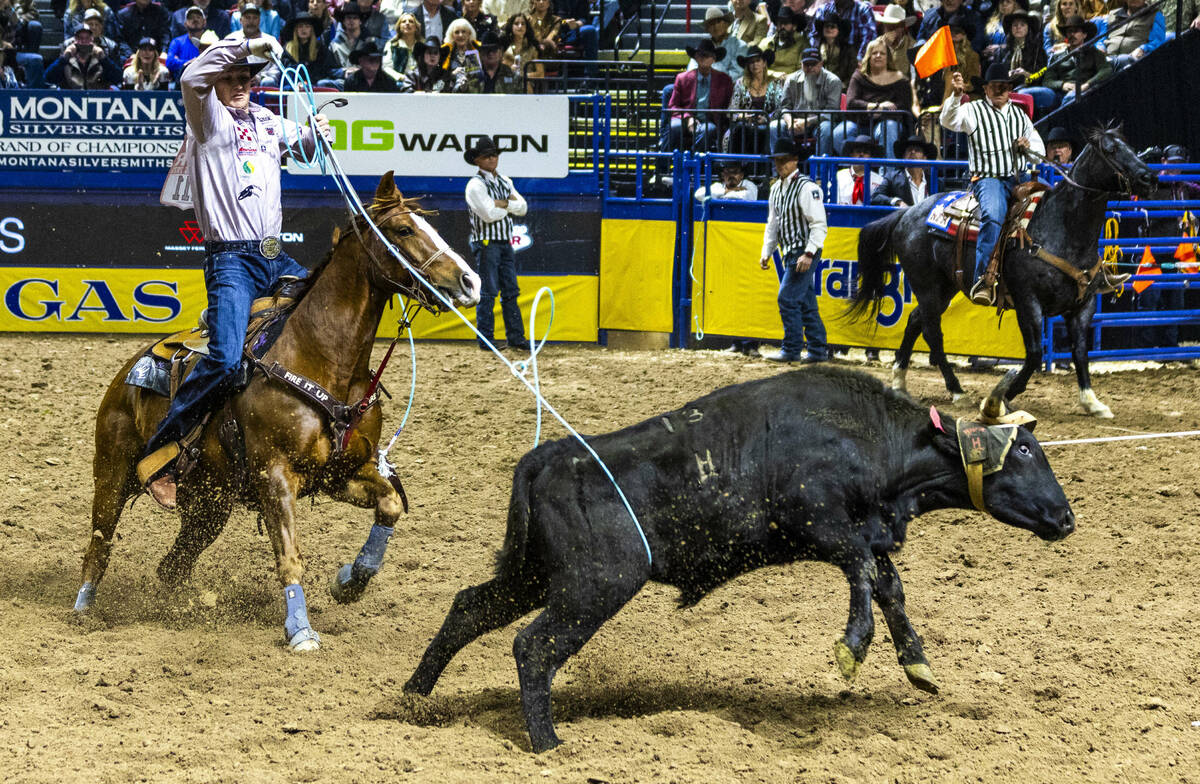 Heeler Lightning Aguilera ropes his calf for a winning time with header Kaden Profili during th ...