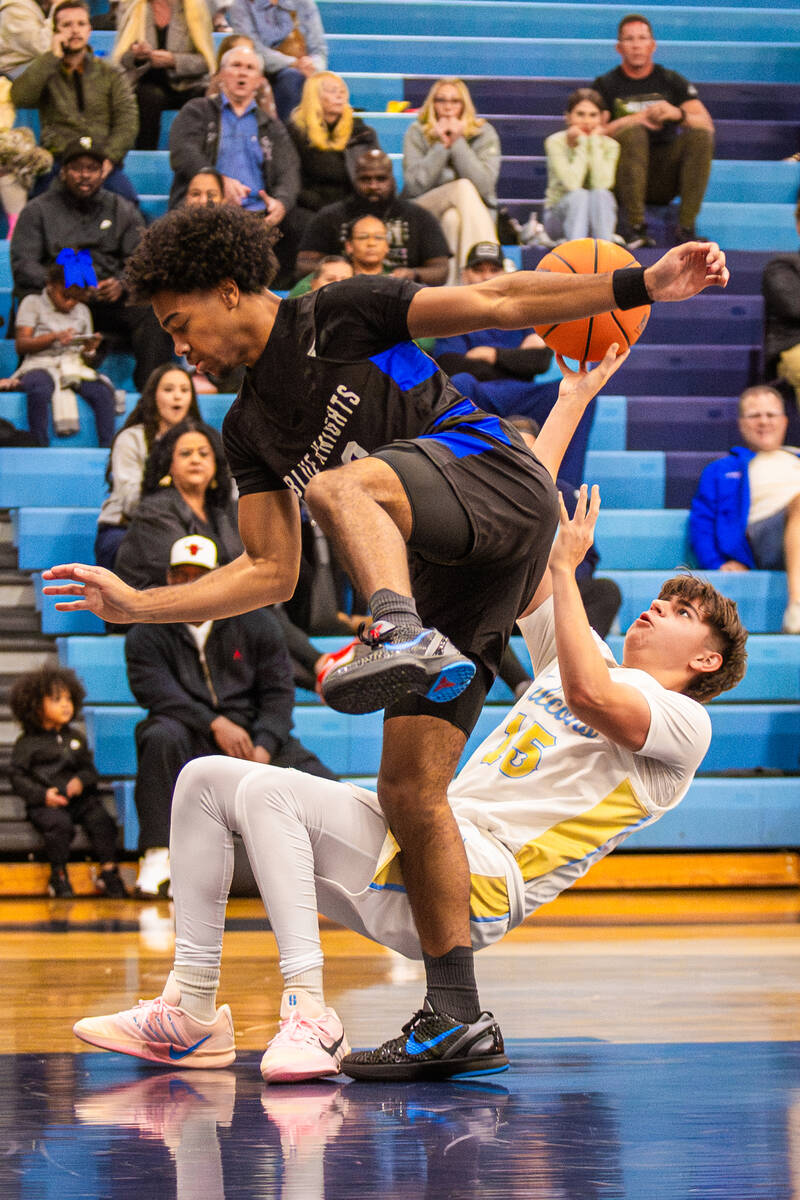 Foothill guard Antonio "Reece" Velasco (15) falls while attempting a basket during a ...