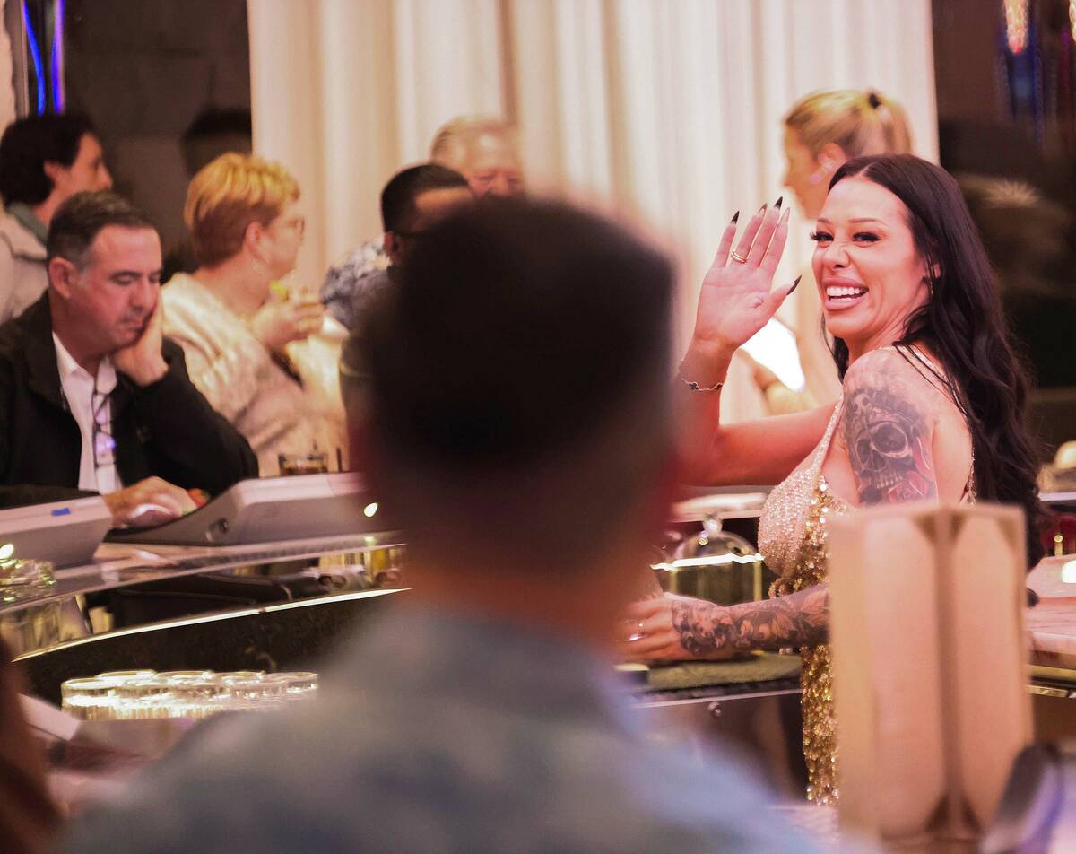 Bartenders serve drinks while socializing with guests during the opening of the Durango hotel-c ...