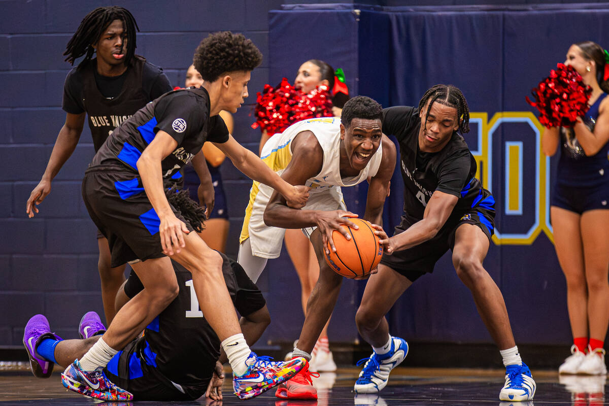 Foothill forward Clinton Ezugha (14) fights to keep possession of the ball during a basketball ...
