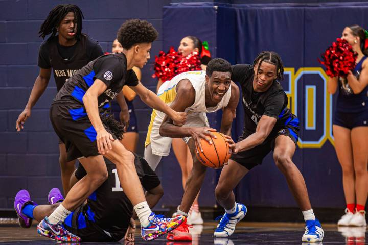 Foothill forward Clinton Ezugha (14) fights to keep possession of the ball during a basketball ...