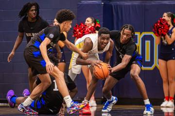 Foothill forward Clinton Ezugha (14) fights to keep possession of the ball during a basketball ...