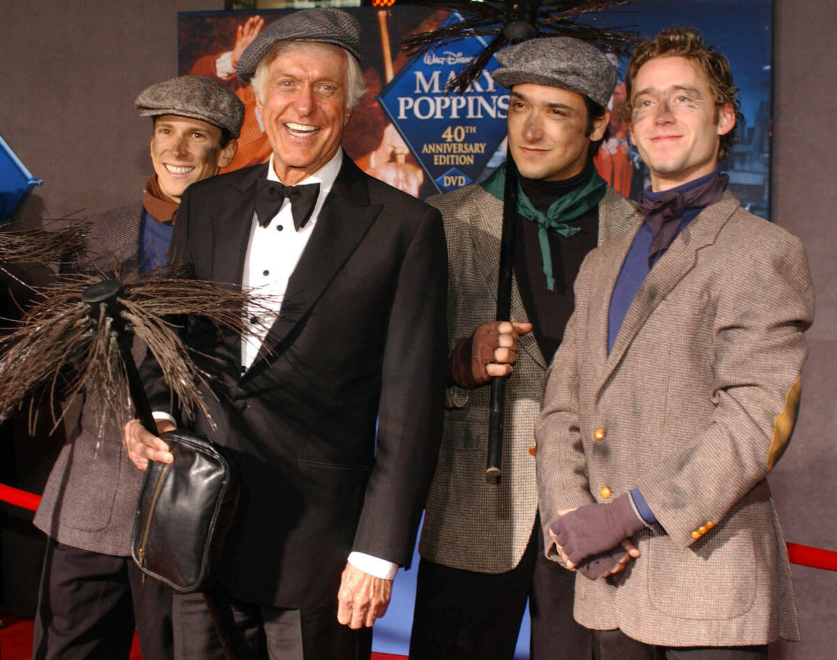 FILE - Dick Van Dyke poses with chimney sweeps during arrivals to the 40th anniversary and re-p ...