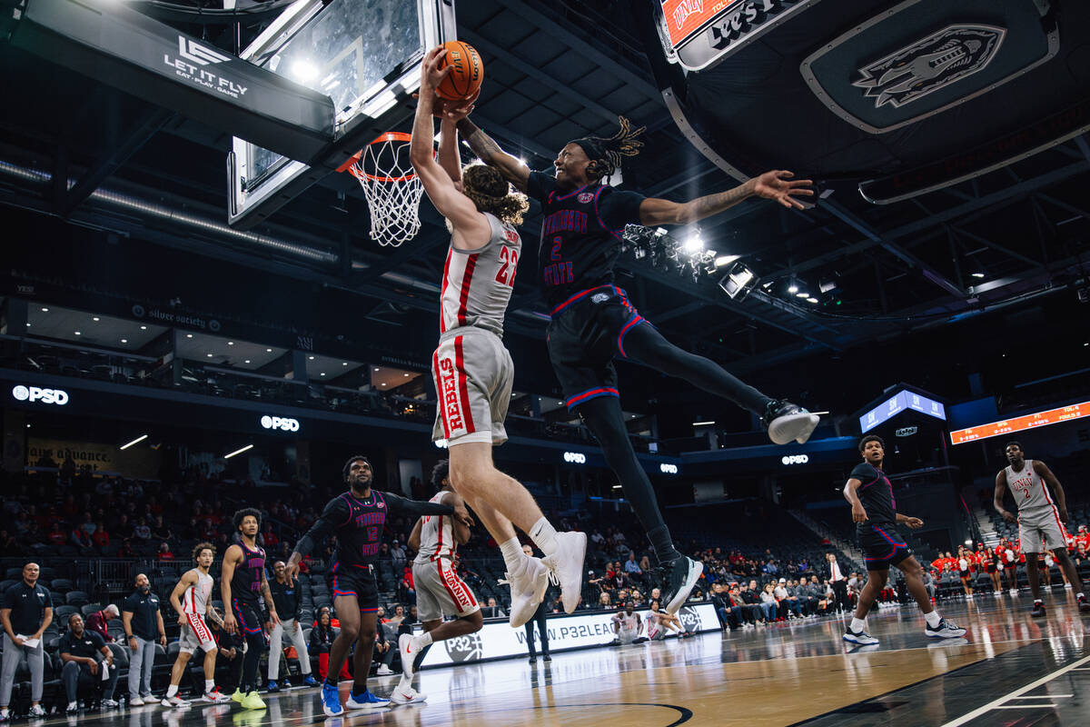 UNLV forward Walter Brown (22) puts up a shot against =Tennessee State Tigers guard Travis Harp ...