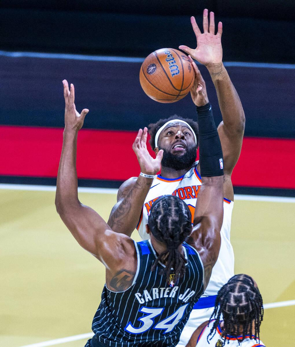 New York Knicks center Mitchell Robinson (23) attempts to defend the basket from Orlando Magic ...