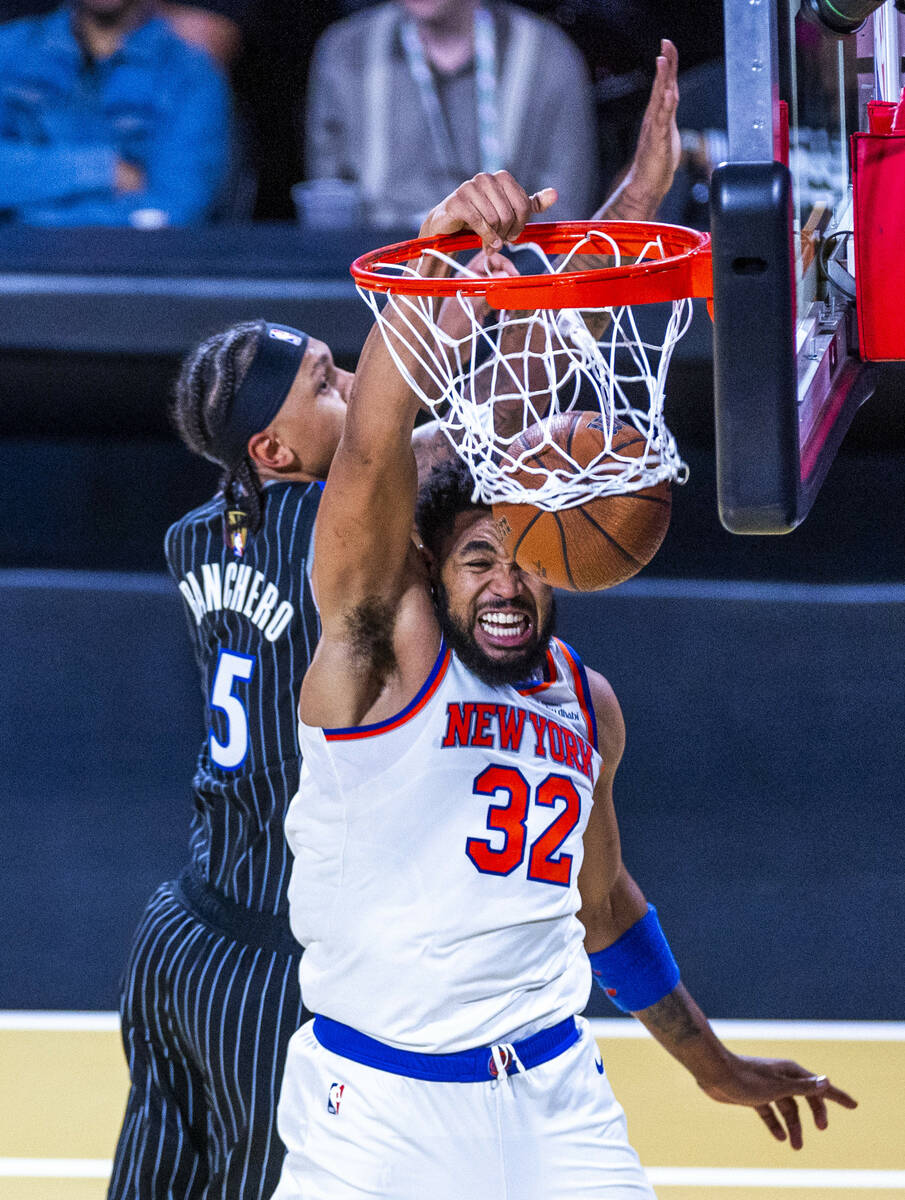 New York Knicks center Karl-Anthony Towns (32) dunks the ball late over Orlando Magic forward P ...