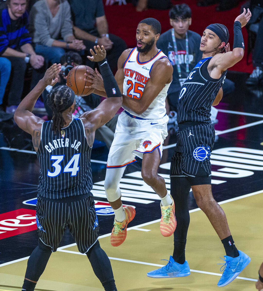 New York Knicks guard Mikal Bridges (25) works to split the defense of Orlando Magic center Wen ...