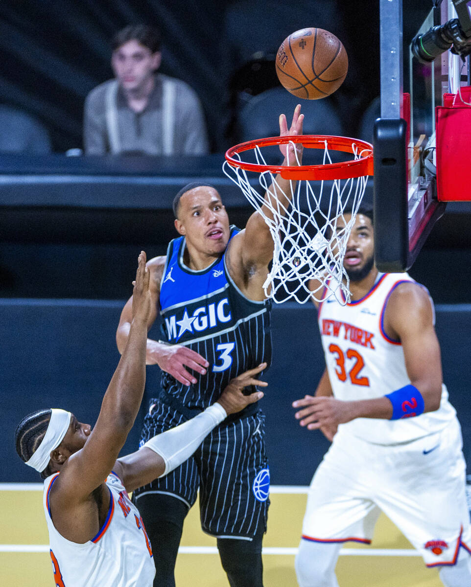 Orlando Magic guard Desmond Bane (3) lays the ball in over guard Jordan Clarkson (00) with n32 ...