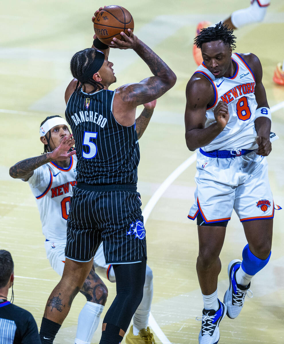 Orlando Magic guard Desmond Bane (3) elevates to shoot past New York Knicks guard Jordan Clarks ...