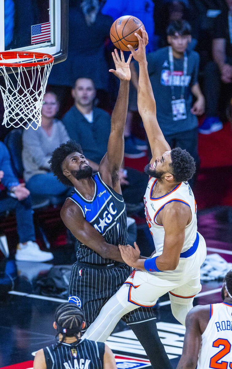 Orlando Magic forward Jonathan Isaac (1) attempts to stop New York Knicks center Karl-Anthony T ...