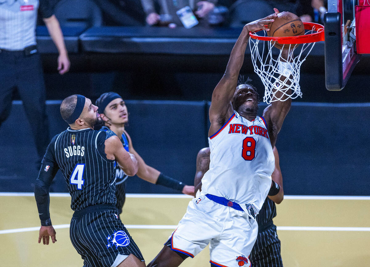 New York Knicks forward Og Anunoby (8) dunks the ball as Orlando Magic guard Jalen Suggs (4) is ...