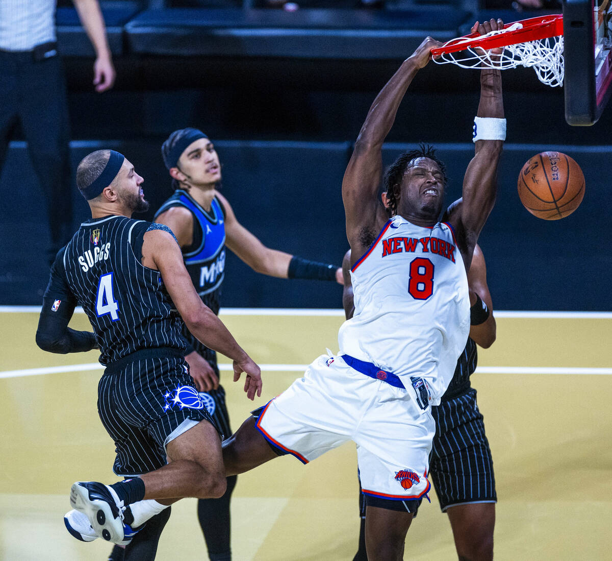 New York Knicks forward Og Anunoby (8) dunks the ball as Orlando Magic guard Jalen Suggs (4) is ...