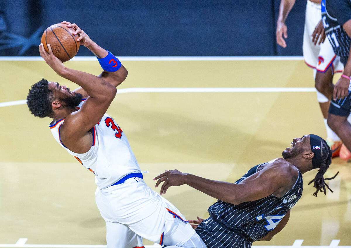 New York Knicks center Karl-Anthony Towns (32) gets position for a shot under the basket agains ...