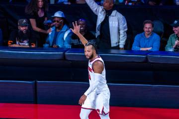 New York Knicks guard Jalen Brunson (11) signals another three-point basket against the New Yor ...