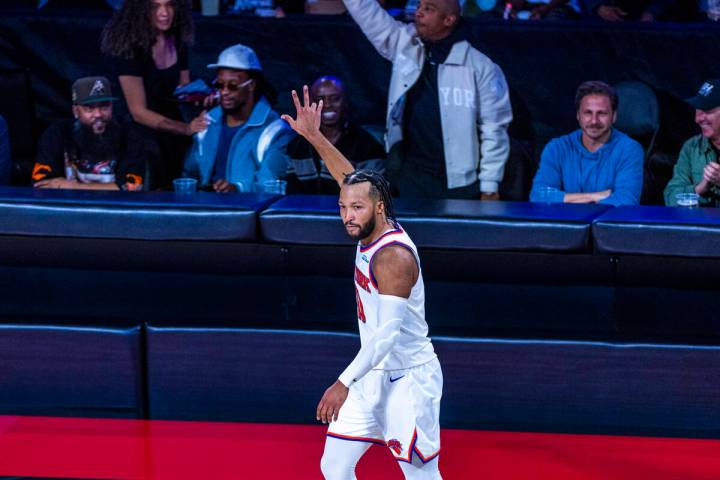 New York Knicks guard Jalen Brunson (11) signals another three-point basket against the New Yor ...
