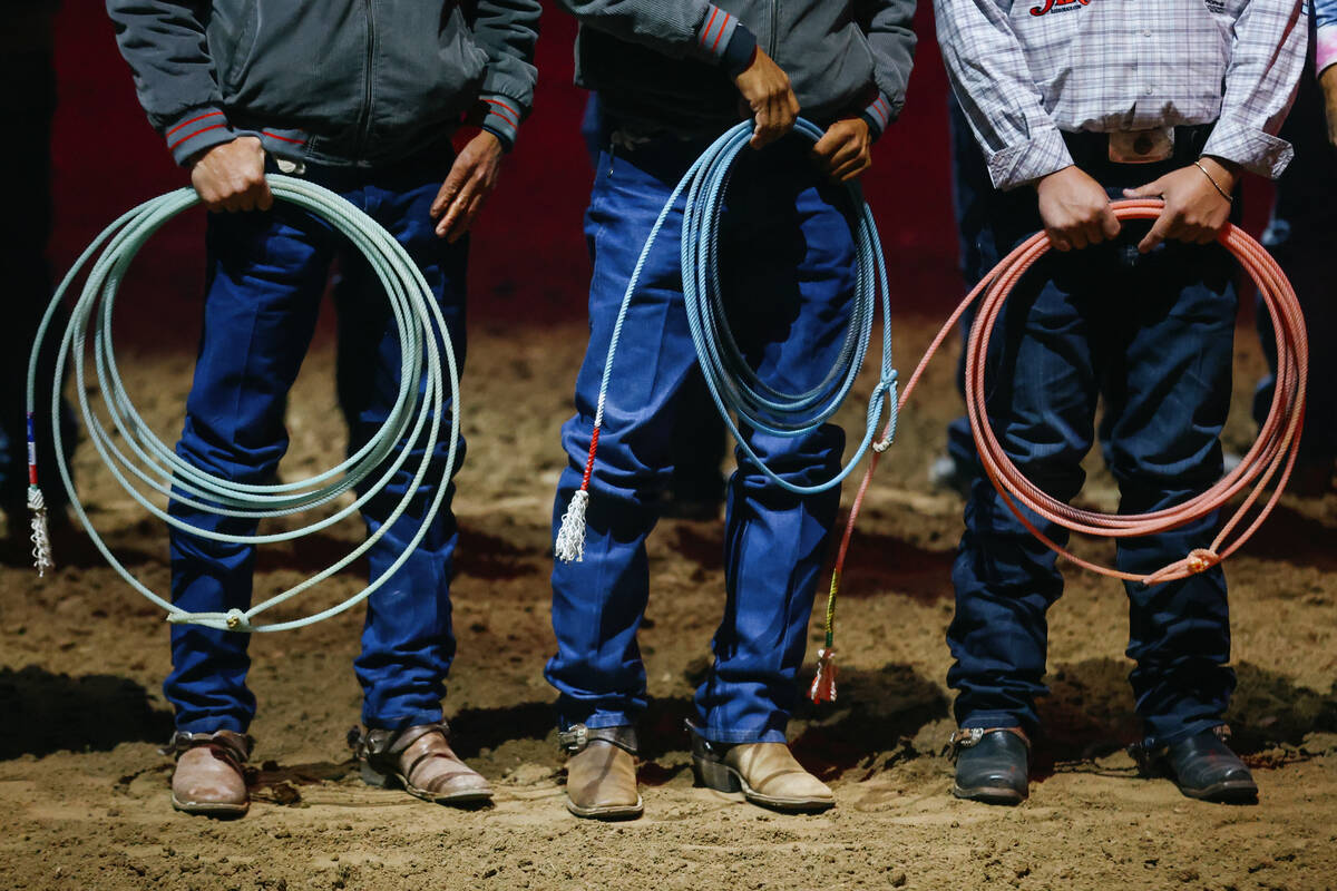 Roping contestants stand during their introduction to the audience in the 10th go-round of the ...