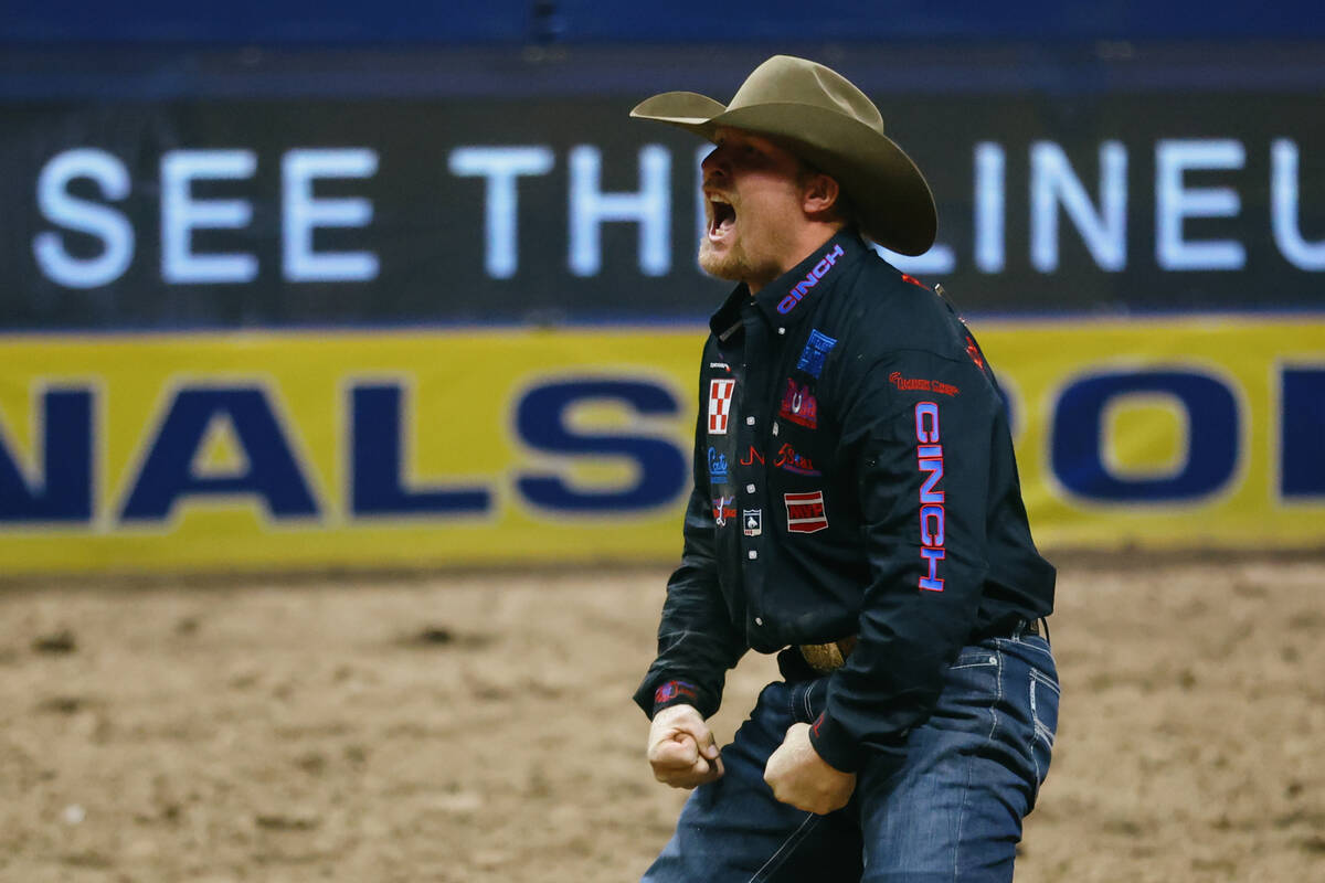 Stetson Jorgensen celebrates his score after competing in the steer wrestling event in the 10th ...