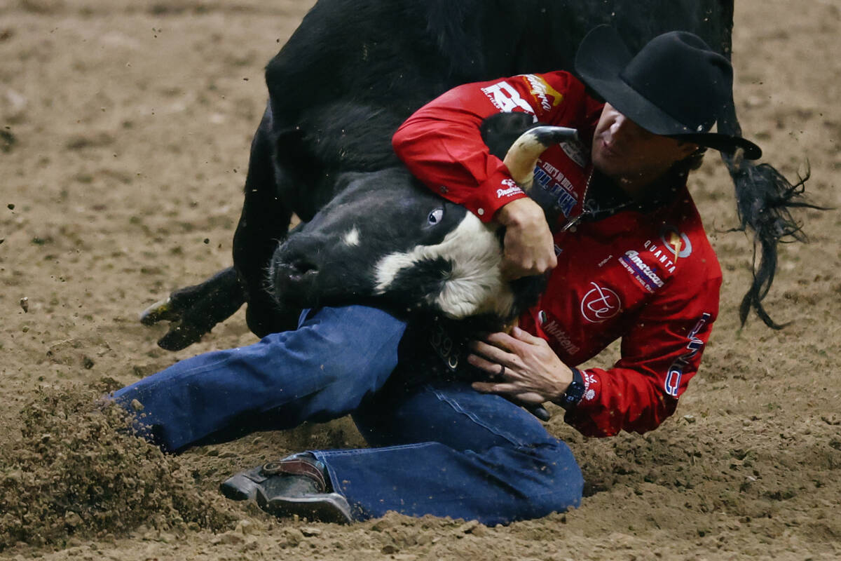 Rowdy Parrott competes in the steer wrestling event in the 10th go-round of the National Finals ...