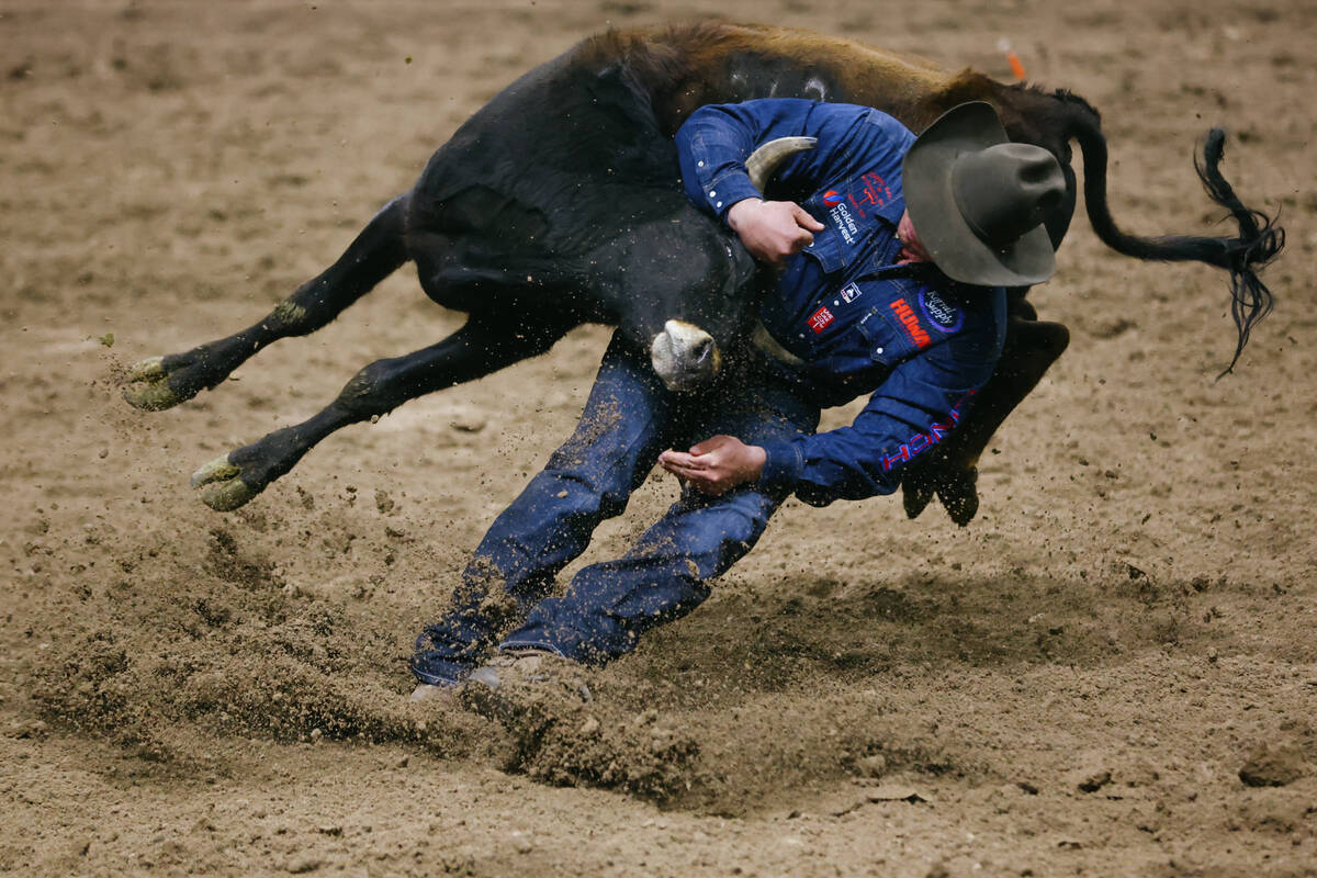 Bridger Andersen competes in the steer wrestling event in the 10th go-round of the National Fin ...