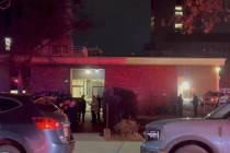 In this image from video, law enforcement officials gather outside the Brown University campus ...