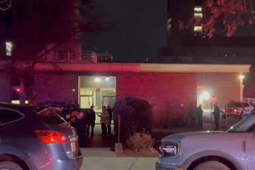 In this image from video, law enforcement officials gather outside the Brown University campus ...