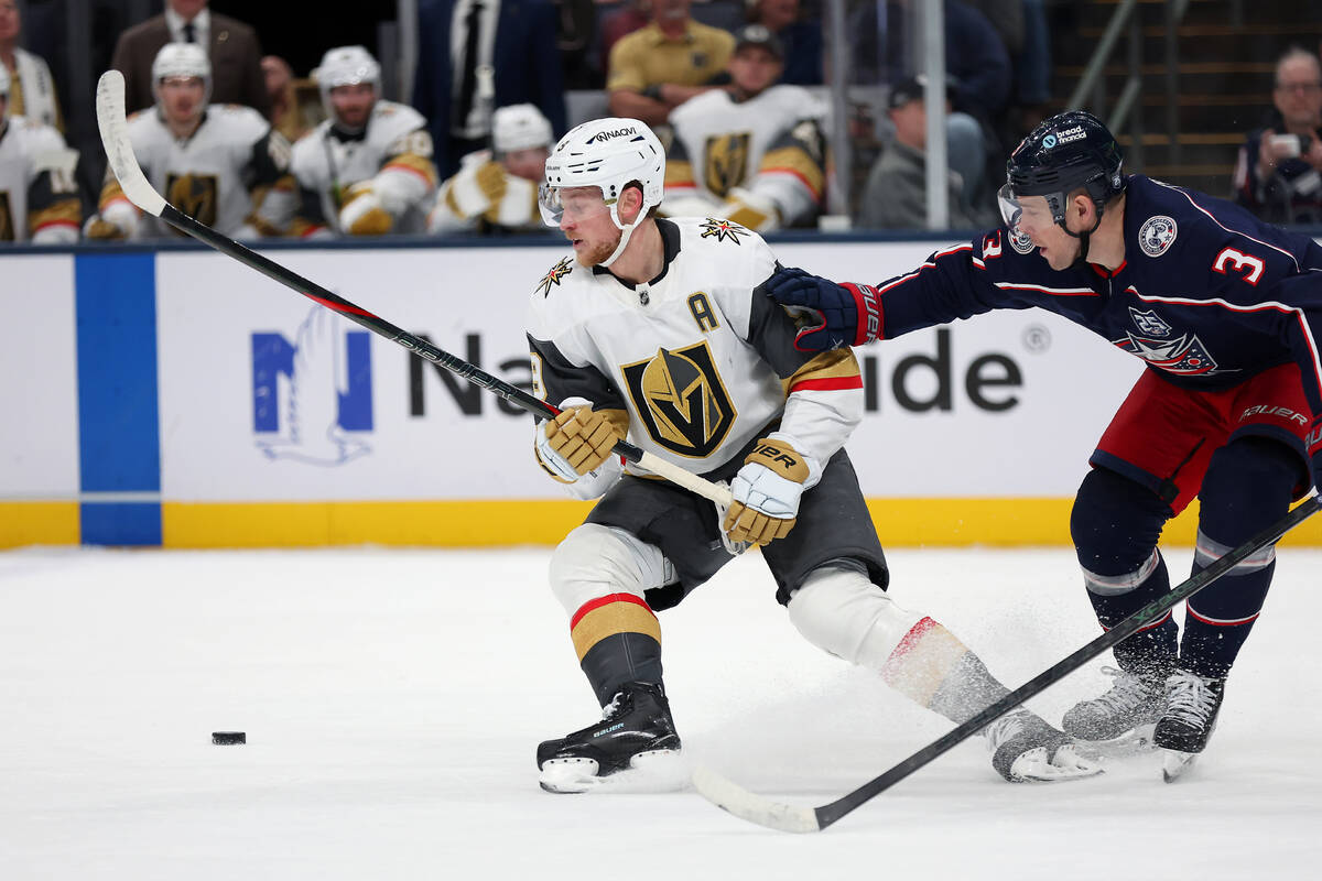 Vegas Golden Knights center Jack Eichel (9) loses the puck as Columbus Blue Jackets center Char ...