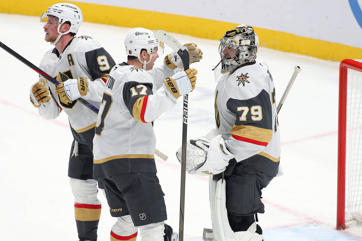 Vegas Golden Knights goaltender Carter Hart (79) is congratulated by Vegas Golden Knights defen ...