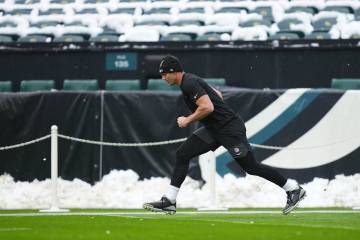 Las Vegas Raiders tight end Brock Bowers warms up before an NFL football game against the Phila ...