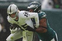 Las Vegas Raiders quarterback Kenny Pickett (15) is tackled by Philadelphia Eagles defensive en ...