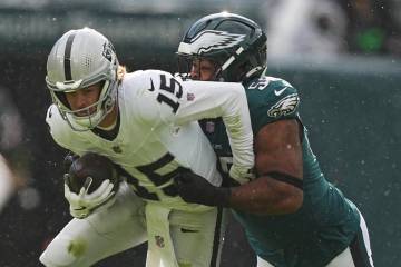 Las Vegas Raiders quarterback Kenny Pickett (15) is tackled by Philadelphia Eagles defensive en ...
